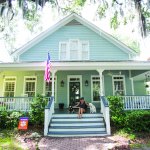 Savannah home with owner and dogs on front porch
